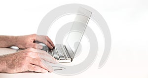 Hands of person using laptop computer against white background