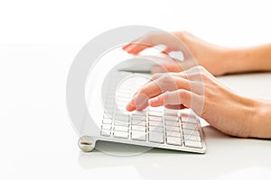 Hands of a person working an a keyboard