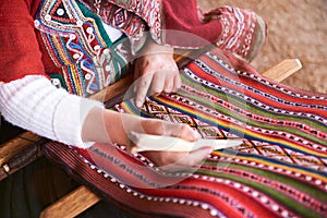 Hands of peruvian woman making alpaca wool photo