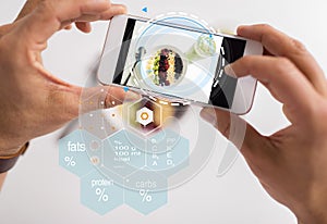 Hands with phone and food nutritional value chart