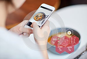 Hands with phone and food nutritional value chart