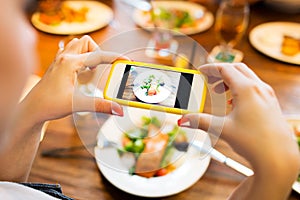 Hands photographing food by smartphone