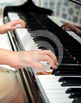 Hands of pianist performing on classical piano