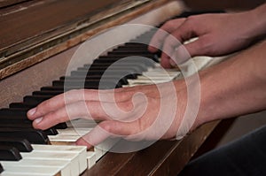 hands of pianist on piano keys