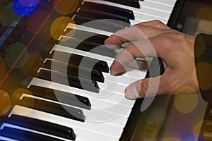 Hands on the piano keyboard electronic organ close-up. Hands of musician play on the piano