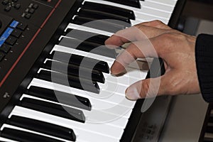 Hands on the piano keyboard electronic organ close-up. Hands of musician play on the piano