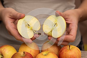 Hands Picking a Fresh Apple. Female hands holding fresh ripe apple