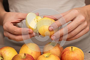 Hands Picking a Fresh Apple. Female hands holding fresh ripe apple