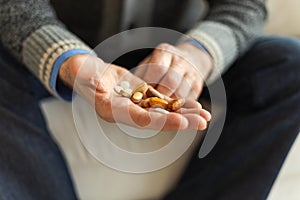 Hands with pills. Senior man hands holding medical pill. Mature old senior grandfather taking medication cure pills