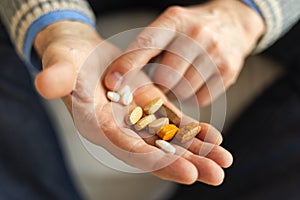 Hands with pills. Senior man hands holding medical pill. Mature old senior grandfather taking medication cure pills