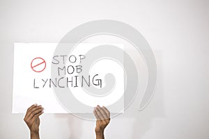 Hands with Placard showing of Stop Mob Lynching on isolated background