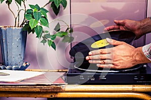 Hands placing LP on turntable