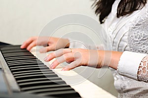 Hands play musical composition on piano
