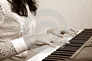 Hands play musical composition on piano