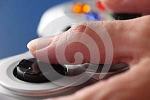 Hands play video game using a gamepad