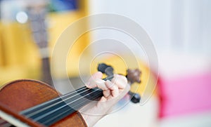 Hands play violin in closed up and selective focus on blur background with copy space