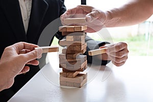 Hands playing blocks wood game, gambling placing wooden block. Concept Risk of management and strategy plan