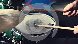 Hands playing drums with drumsticks with rock beat, hihat rythm