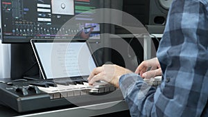 Hands playing on electric midi keyboard piano at home music recording studio. Music concept.