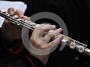 Hands playing flute detail