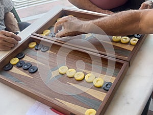 hands playing greek style backgammon