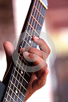 Hands playing guitar strings closeup