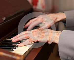 Hands playing a harmonium photo