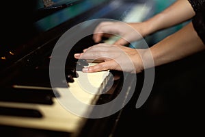 Hands playing music on the piano