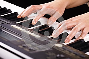 Hands playing music on the piano