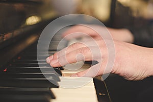 Hands playing the piano (close-up) with oldschool vintage instagram filter