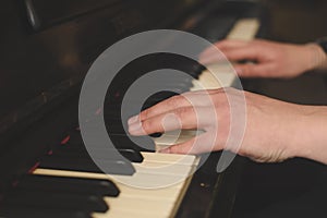 Hands playing the piano (close-up) with oldschool vintage instagram filter