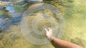 Hands playing and touching the water. Having fun on vacation weekend trip