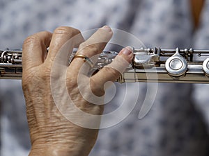 Hands playing traverse flute