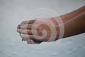 Hands Playing in Wet Sand