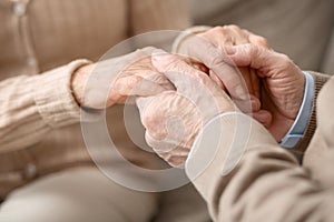 Hands of pleasant aged couple