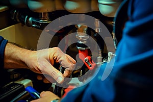 Hands of plumber assembling sink pipes, close up