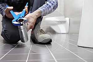 Hands plumber at work in a bathroom, plumbing repair service, as