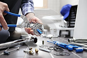 Hands plumber at work in a bathroom, plumbing repair service, as