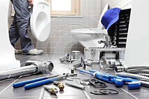 Hands plumber at work in a bathroom, plumbing repair service, as