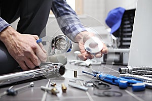 Hands plumber at work in a bathroom, plumbing repair service, as