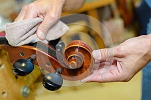 Hands polishing end musical instrument