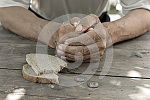 Hands the poor old man& x27;s, piece of bread and change, pennies on