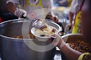 Hands of the poor receive food from the donor`s share. poverty concept