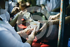 hands of the poor receive food from the donor's share. poverty concept