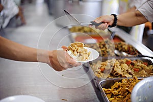 The hands of the poor waiting to receive free food: food distribution