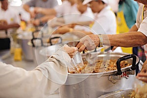 The hands of the poor waiting to receive free food: food distribution