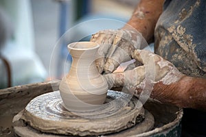 hands of potter on ceramic