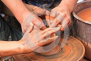 Hands of a potter closeup