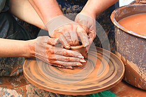 Hands of a potter closeup