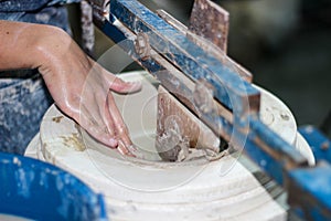 Hands of a potter, creating an bowl using a terraja